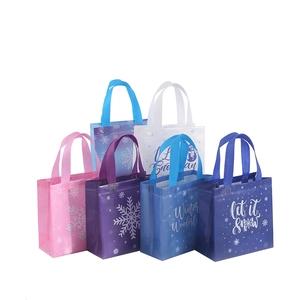 Winter-themed non-woven gift bags with snowflake patterns and festive lettering