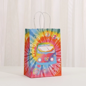 Colorful tie-dye paper gift bag featuring a cartoon bus and retro peace signs with rope handles