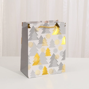 Elegant Christmas white paper gift bag with gold foil snowflake and tree patterns