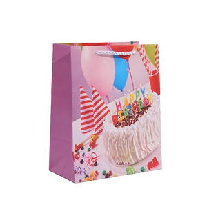 Purple birthday gift bag with cake, balloons and silver woven rope handles on white background