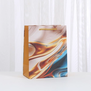 Premium marble pattern paper gift bag with golden braided handles for shopping and parties