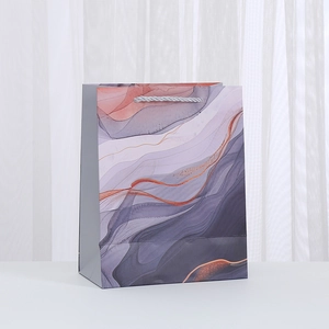 Premium marble pattern paper gift bag with silver rope handles for boutique shopping