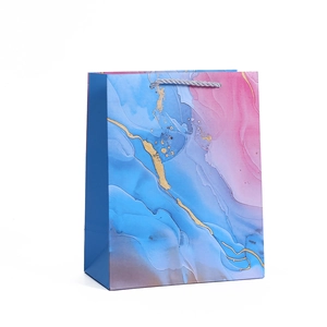 Elegant marble pattern paper gift bag with gold foil accents and silver rope handles