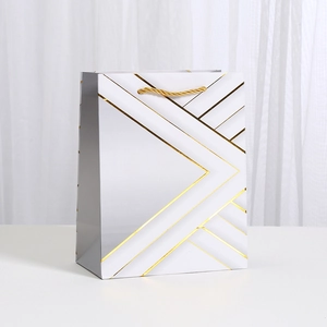 White and gold geometric pattern gift bag with luxury woven handles for parties