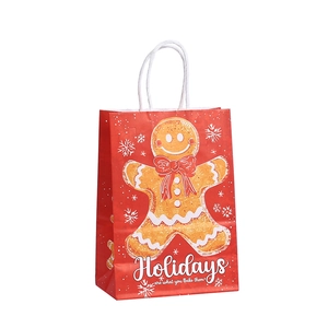 Sac cadeau de Noël en papier kraft rouge avec bonhomme de pain d'épice et anses blanches