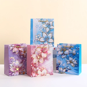 Elegant Floral Lily Paper Gift Bag With Gold Hot Stamping White Cardboard Handbag With Handles For Wedding Party Gift Packaging