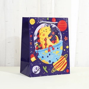 Purple paper gift bag featuring cartoon space dinosaur prints and silver braided rope handles