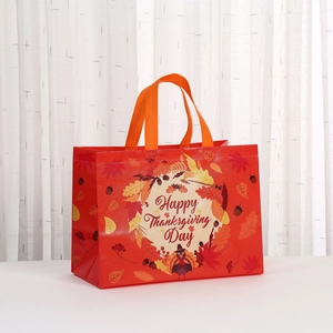 Close-up of Happy Thanksgiving non-woven tote bag with turkey and autumn leaves print