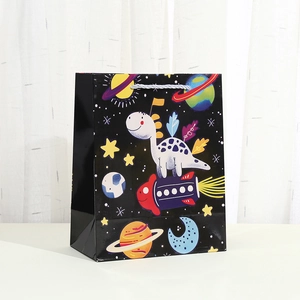 Cartoon space dinosaur gift bag with blue handles and cosmic planetary prints
