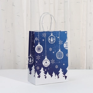 Blue Christmas paper gift bag with white snowflake and holiday tree prints and rope handles