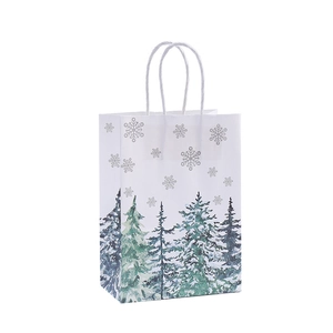 White Christmas kraft paper gift bag featuring blue pine trees and sturdy twist handles
