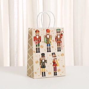 Detail of Christmas Nutcracker gift bag with five colorful soldiers and white paper handles