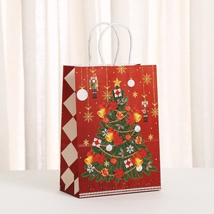Festive red Christmas Nutcracker paper gift bag with golden bells and snowflake patterns