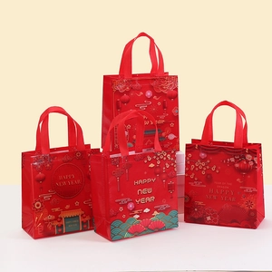 Detail of red non-woven gift bags with festive Chinese New Year patterns and gold lettering