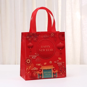 Red waterproof non-woven gift bag with festive New Year patterns and gold lettering