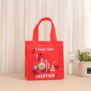 Detail of red non-woven gift bag with science theme print and reinforced handles
