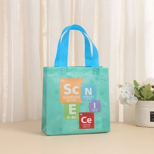 Detail of mint green gift bag with printed chemical periodic table and scientific formulas