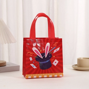 Detail of red non-woven gift bag with magic rabbit print and yellow striped edge