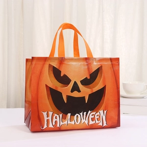 Orange non-woven Halloween gift bag with black pumpkin face and wide handles