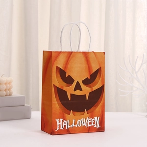 Orange Halloween gift bag with pumpkin face, white rope handles, and festive print