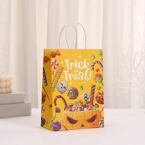 Yellow Halloween paper gift bag with Trick or Treat print and white rope handles