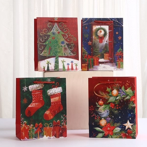 Set of four Christmas cartoon paper gift bags with holiday wreath and tree prints