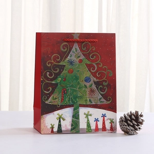 Red Christmas gift paper bag with abstract green tree illustration and red rope handles