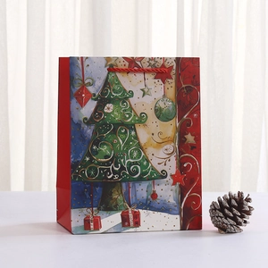 Christmas paper gift bag featuring a festive tree illustration and red rope handles