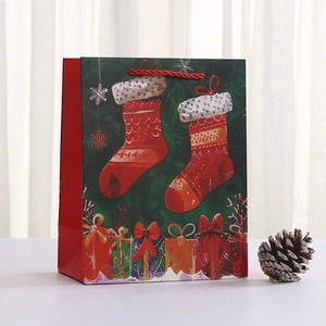 Christmas wreath gift bag with festive stockings and snowflake patterns for holiday candies