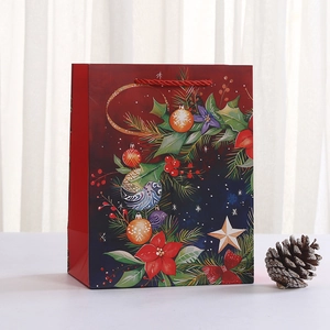 Christmas wreath gift bag with red rope handles and festive holiday illustrations