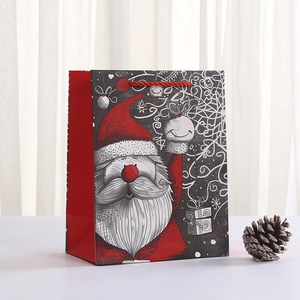 Christmas Santa Claus paper gift bag with red rope handles and festive snowflake design