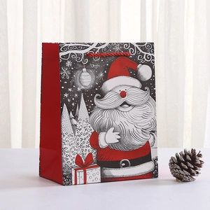Detail of red Christmas gift bag with Santa Claus print and red rope handles