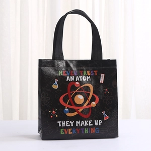 Close-up of black non-woven shopping bag with colorful scientific atom print and quotes