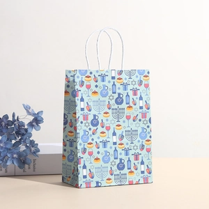 Detailed Hanukkah gift bag with Menorah and Dreidel prints featuring blue twisted handles