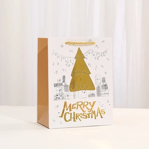 White Christmas paper gift bag with gold foil tree and Merry Christmas greeting
