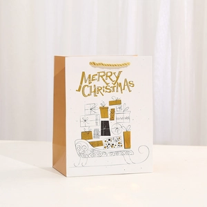 White and brown Christmas paper gift bag with gold Merry Christmas print and rope handles
