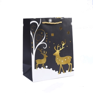 Christmas reindeer gift bag in matte black with gold reindeer print and golden rope handles