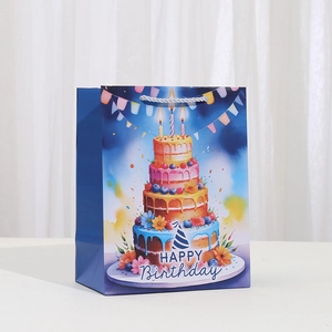 Navy blue birthday gift bag with rainbow cake illustration and silver nylon handles