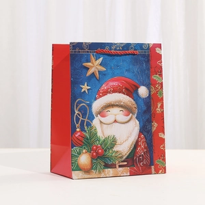 Detail of Christmas gift bag with Santa Claus illustration and red woven handles