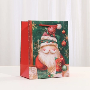 Christmas gift bag with cartoon Santa Claus illustration and red rope handles
