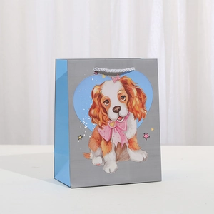 Cartoon Cavalier King Charles Spaniel gift paper bag with white rope handles and blue hearts