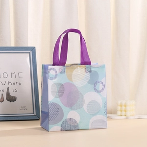 Waterproof non-woven gift bag with purple geometric patterns and sturdy handles
