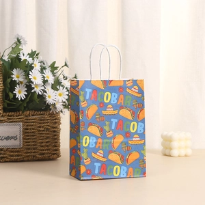 Detail view of Taco Bar theme paper gift bag with festive illustrations and white handles