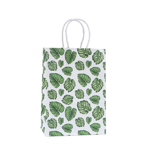 Tropical monstera leaf print kraft paper gift bag with white twisted rope handles