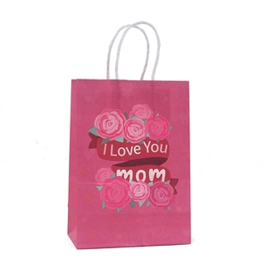 Pink Mother's Day gift bag with floral print and white rope handles on white background
