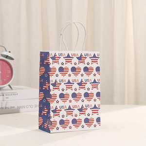 Detail of white paper gift bag with USA flag patterns and twisted rope handles