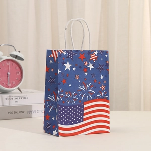 Detail of USA flag themed gift bag with fireworks design and durable white paper handles