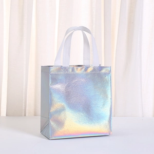 Detail of silver laser non-woven gift bag showing holographic rainbow effect and handles