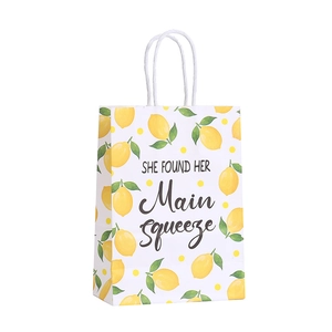 Lemon print kraft paper gift bag with white rope handle and She Found Her Main Squeeze text