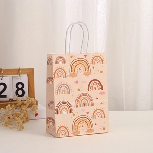 Detail of bohemian rainbow kraft paper gift bag with white twisted rope handle and prints